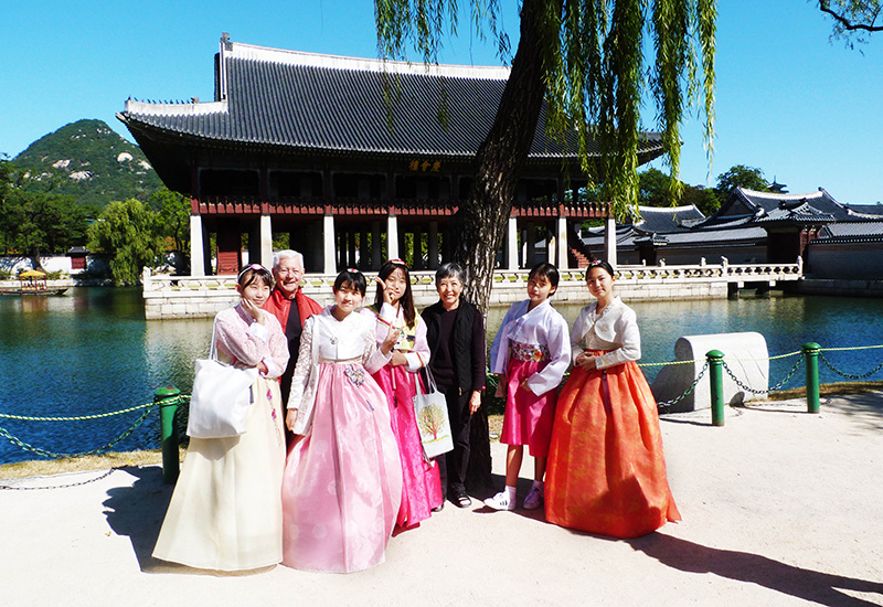 The couple taking pictures with the locals in Seoul