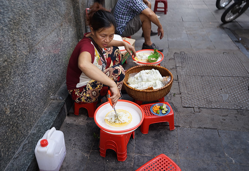A Woman Selling Street Food in Hanoi