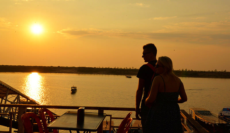 A couple watching sunset in Tonle Sap Lake, Siem Reap
