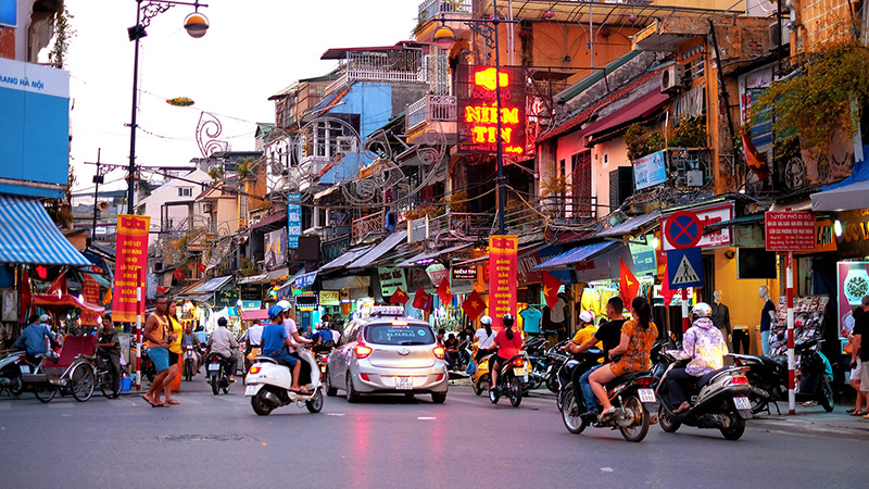 Crossing the road in Hanoi's old quarter, Hanoi, Vietnam Stock