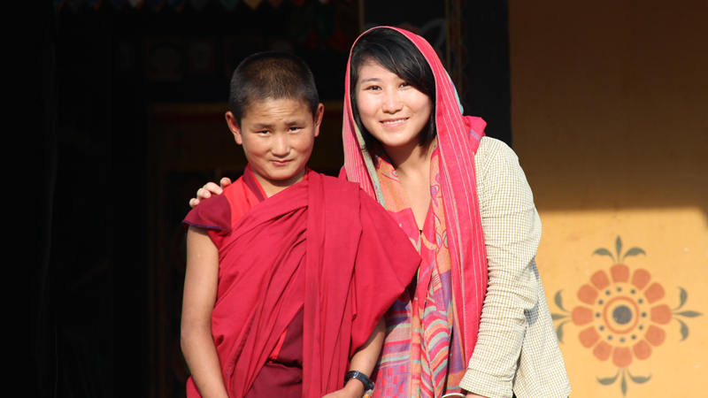 Odynovo Travel Consultant Zoe with a Monk in Punakha Dzong