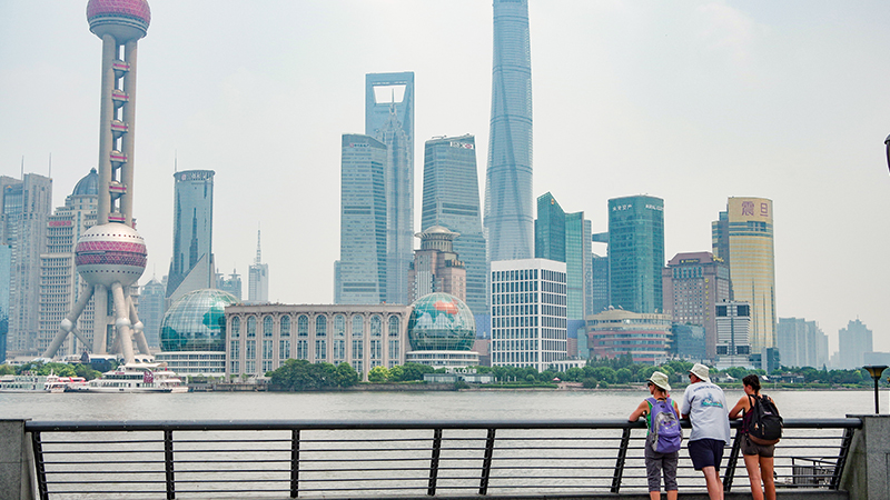 Walk along the waterfront at the Bund