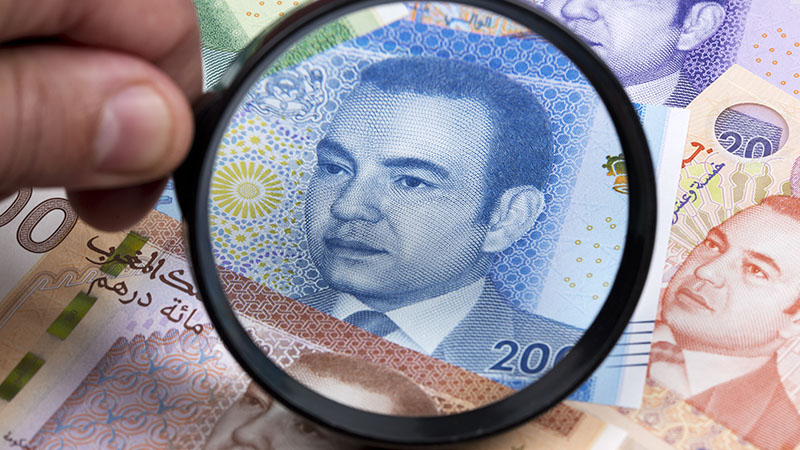 Moroccan Dirham in a Magnifying Glass