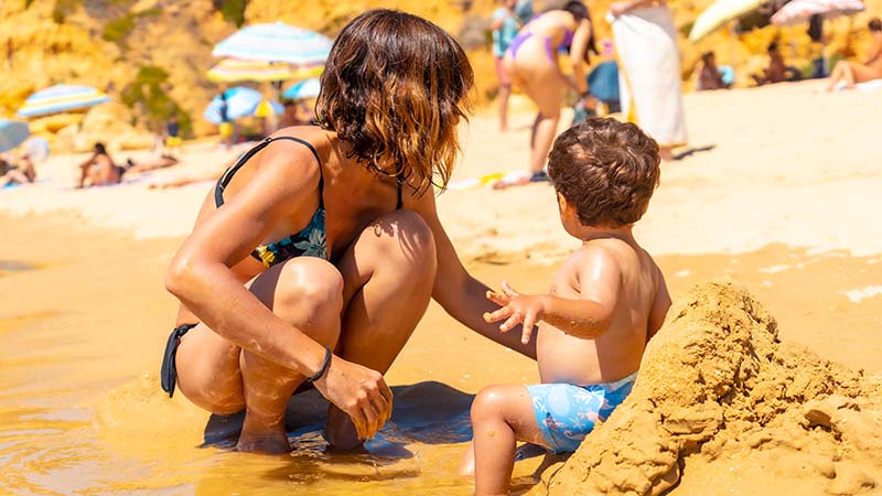 Woman and Baby Playing on an Algarve Beach