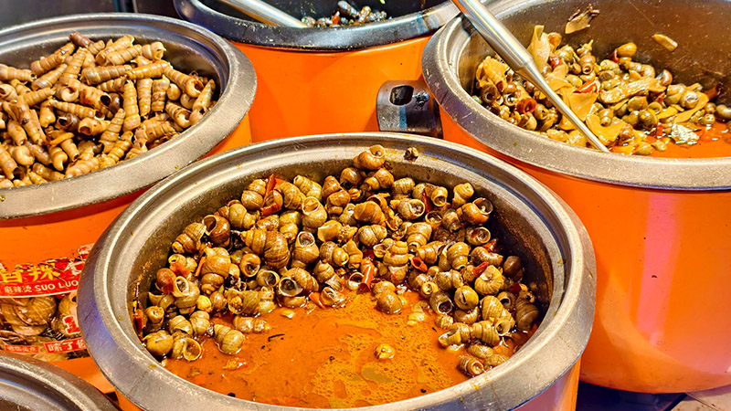 Fried snails sold in night market in Guilin