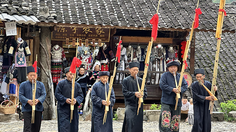 Miao people play lusheng, a traditional instrument