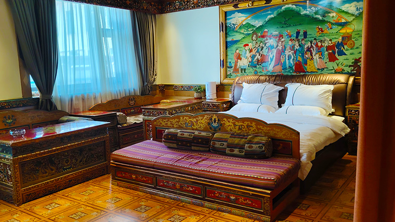 A clean hotel room with Tibetan decorations