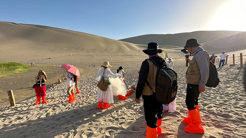 Wear shoe covers and hike the Mingsha Mountain