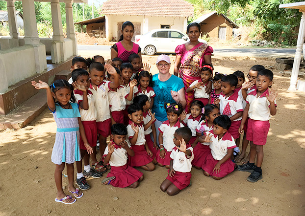Smiling students and teachers took photos with Jill.