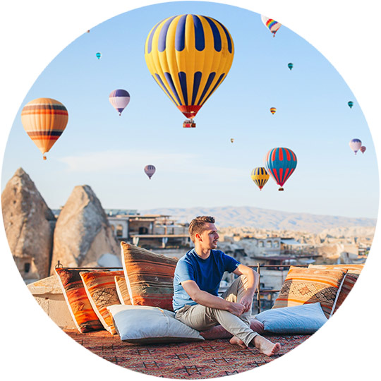 Enjoying hot air balloons from the rooftop in Cappadocia